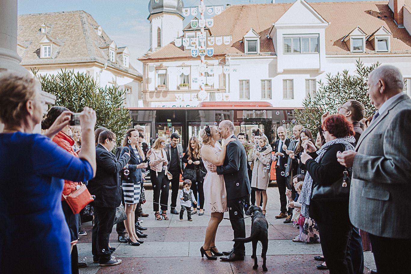 Hochzeitsgesellschaft steht mit dem Brautpaar auf dem Marktplatz in Speyer