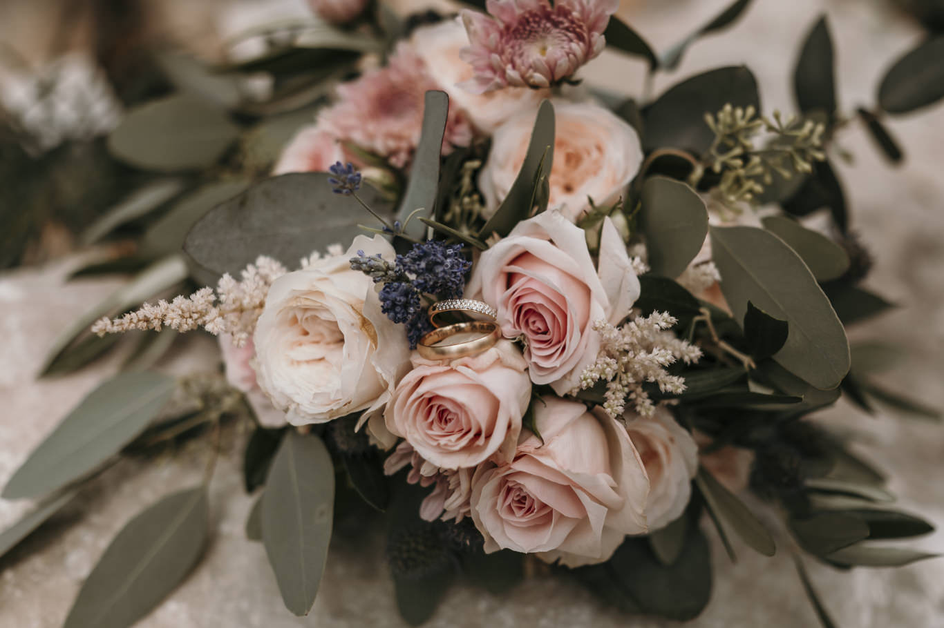 Nahaufnahme eines rosafarbenen Brautstraußes mit Rosen und Eukalyptus