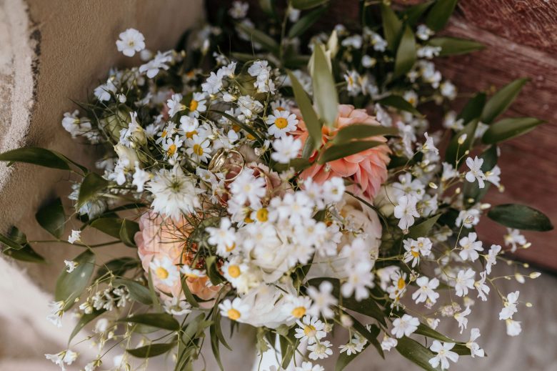 Hochzeitsstrauß aus weißen Wiesenblumen und apricotfarbenen Rosen
